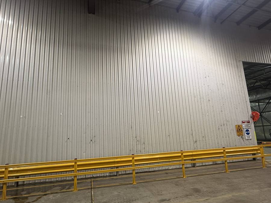 Warehouse wall cladding before cleaning